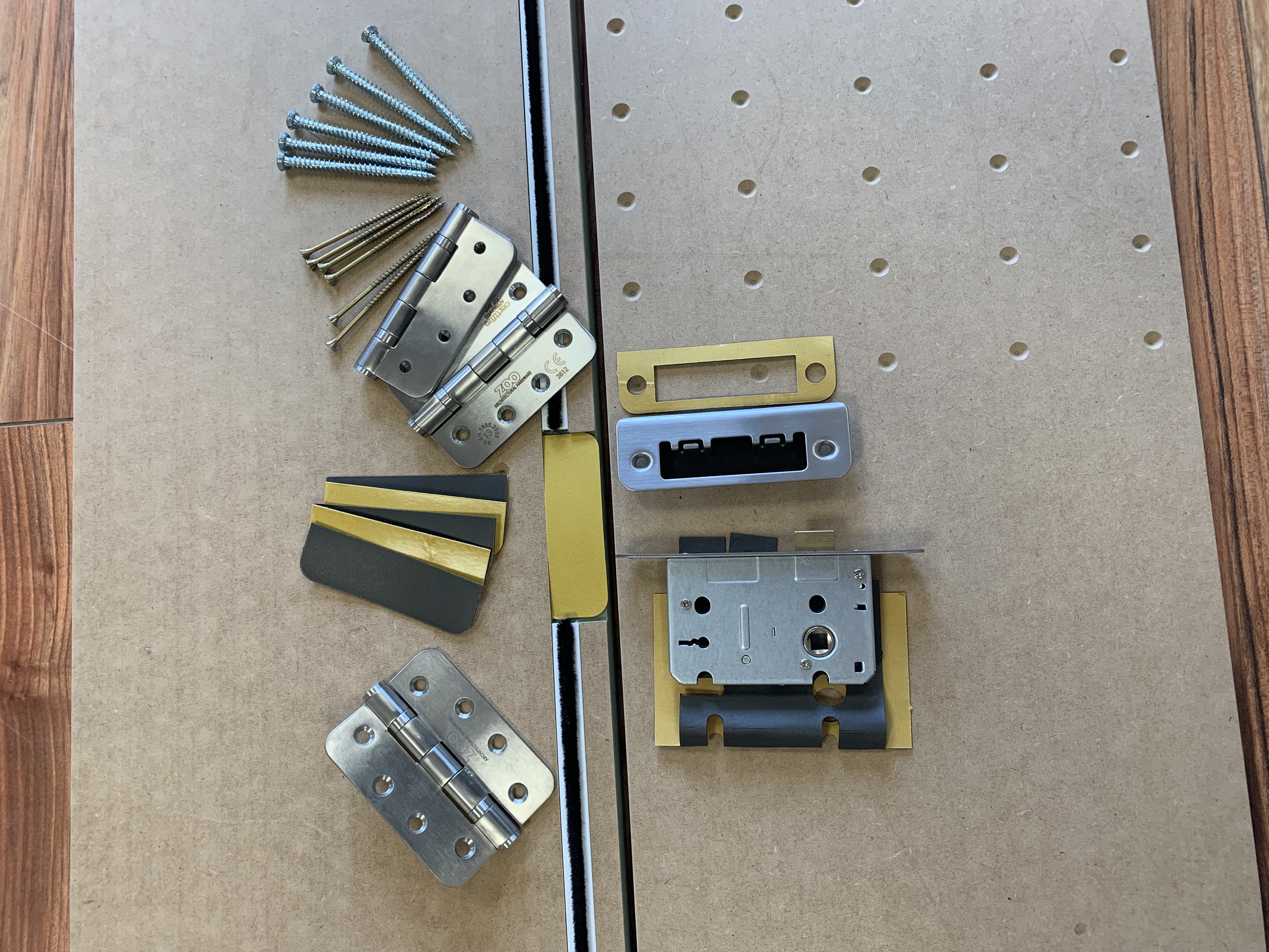 Close up of mortise lock, keep plates, hinges and intumescent fire seals